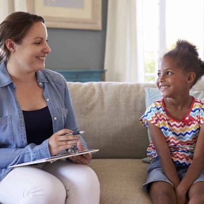 Young Girl Talking With Counselor At Home